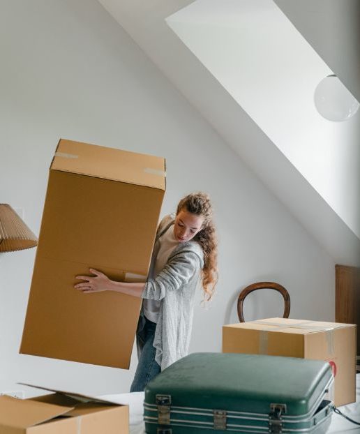 woman-carrying-boxes-in-new-apartment