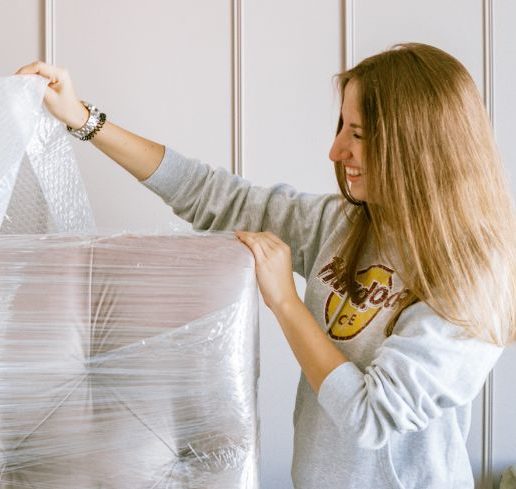woman-removing-the-plastic-wrap-of-a-furniture