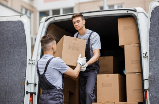 two-young-handsome-movers-wearing-uniforms-are unloading packages
